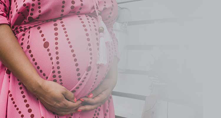 Pregnancy bump in pink dress 35 weeks